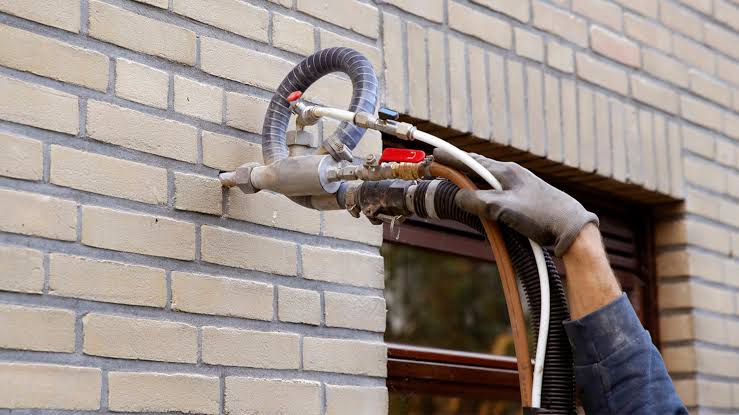 External wall insulation installation team at work
